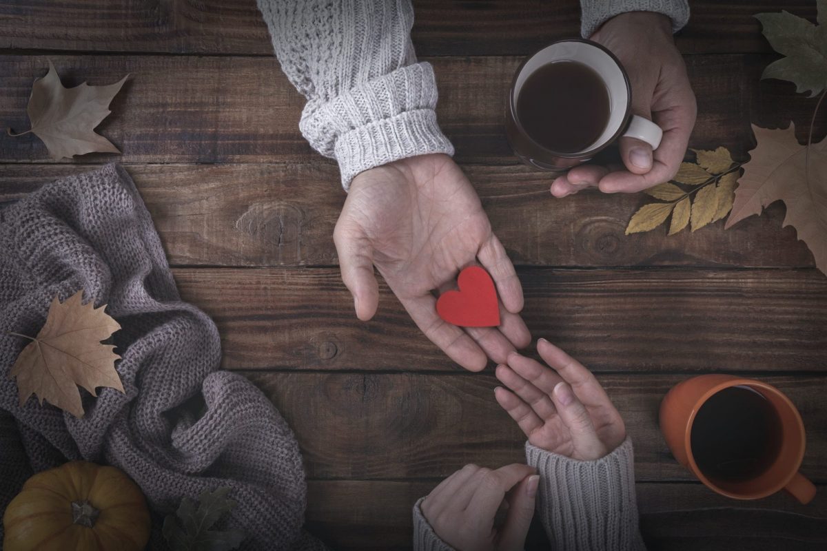 Loving couple holding a heart in hands